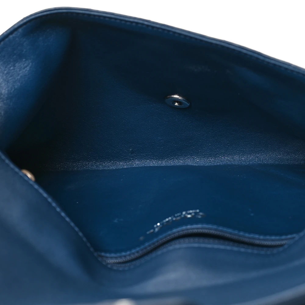 Interior view of the navy Ch@nel Flap Clutch showing the matching leather lining and zipper pocket