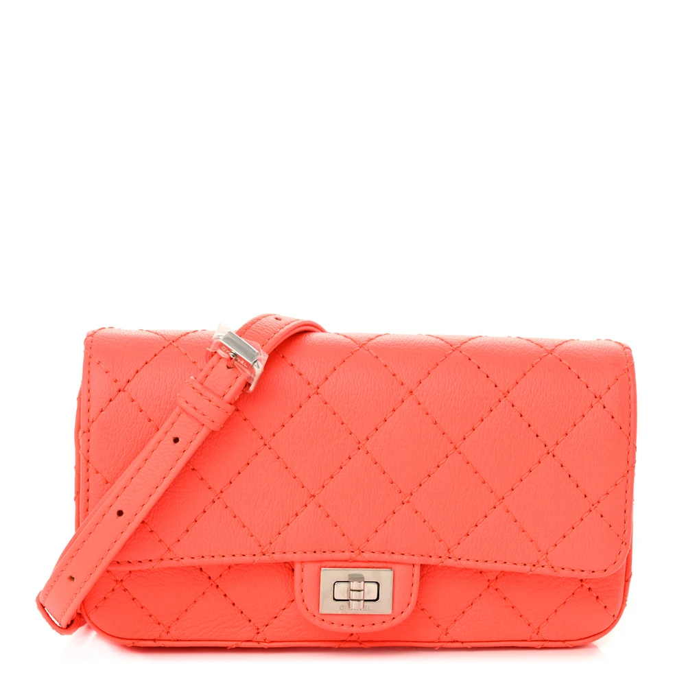 Front view of the vibrant orange Ch@nel Reissue Flap Belt Bag with silver-tone chain waist strap