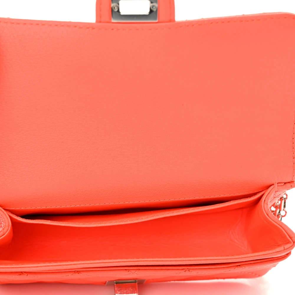Interior view of the orange Ch@nel Reissue Flap Belt Bag showing the matching leather-style lining and patch pocket
