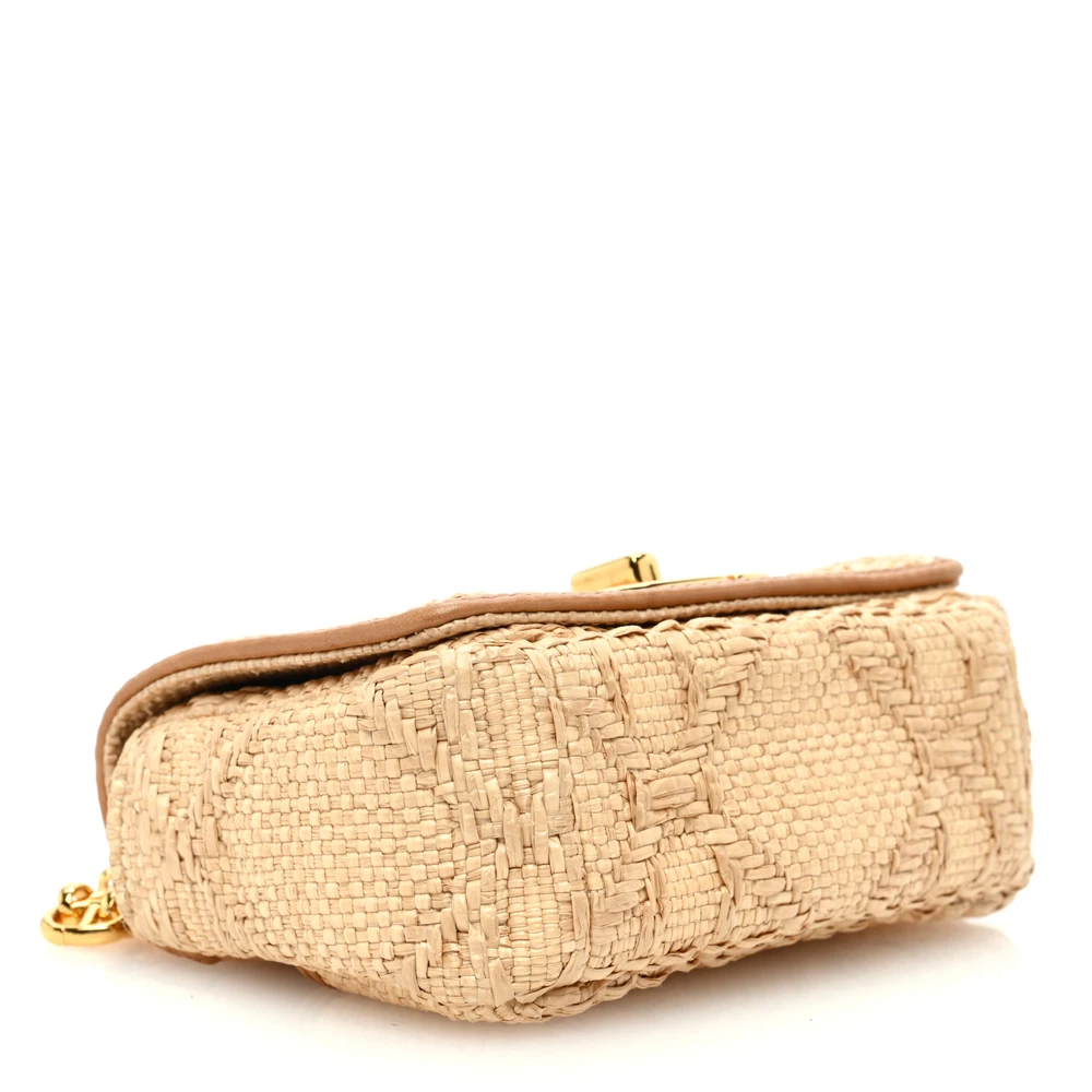Bottom view of the natural raffia D!0r Micro Caro Bag featuring the Macro Cannage motif