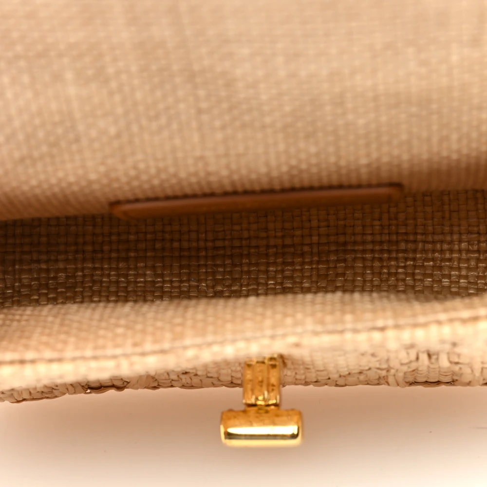 Interior view of the natural raffia D!0r Micro Caro Bag with compact storage and card slots