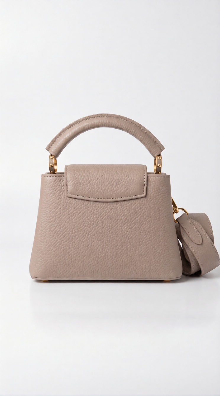 Back view of the Galet taupe Lou!S Vuiton Capucines Mini with floral top flap and gold-tone hardware