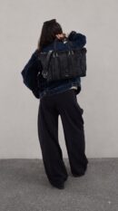 Model carrying the black Maxi D!0r Oblique jacquard D!0r Weekender 25 Bag