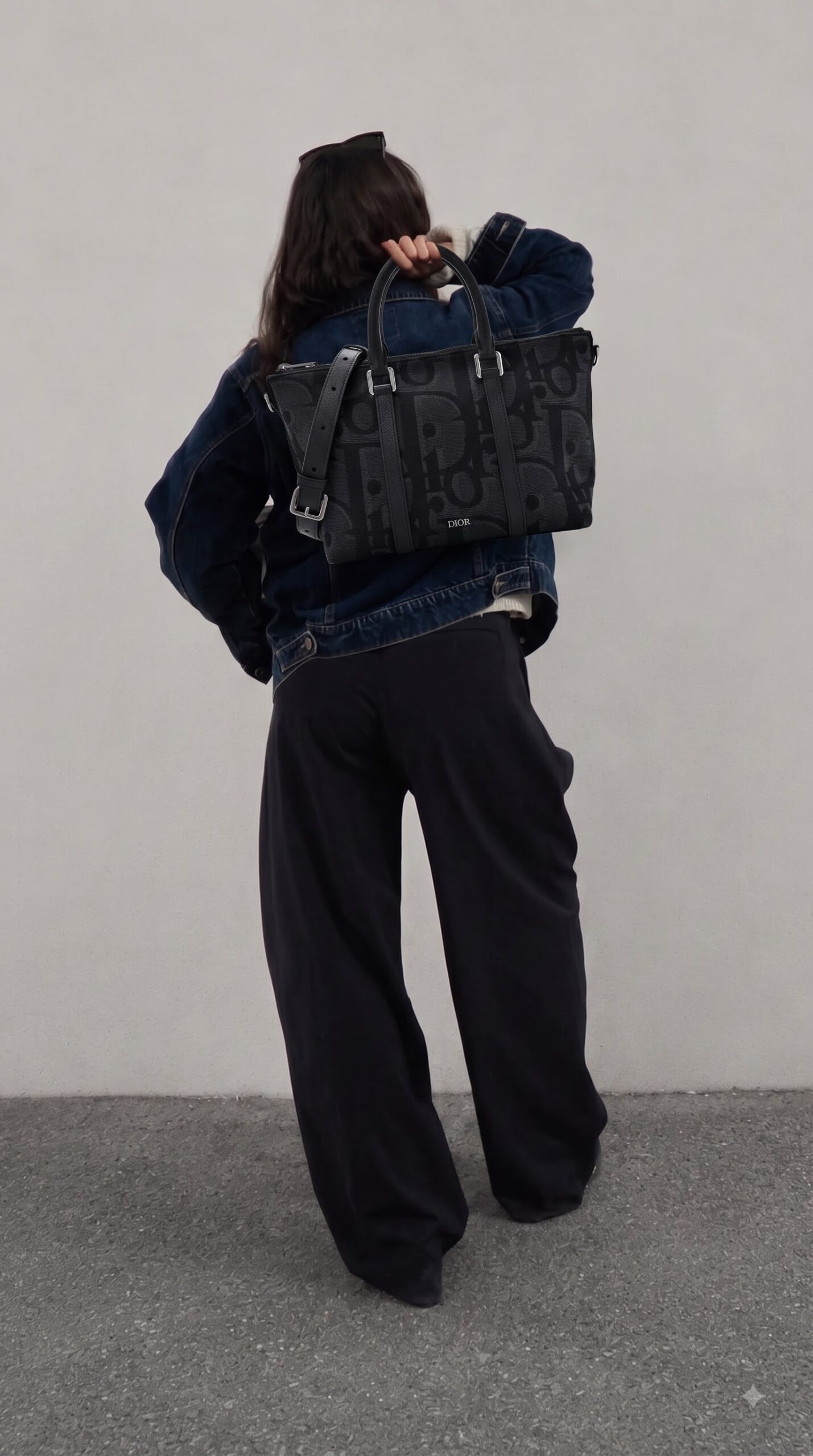 Model carrying the black Maxi D!0r Oblique jacquard D!0r Weekender 25 Bag