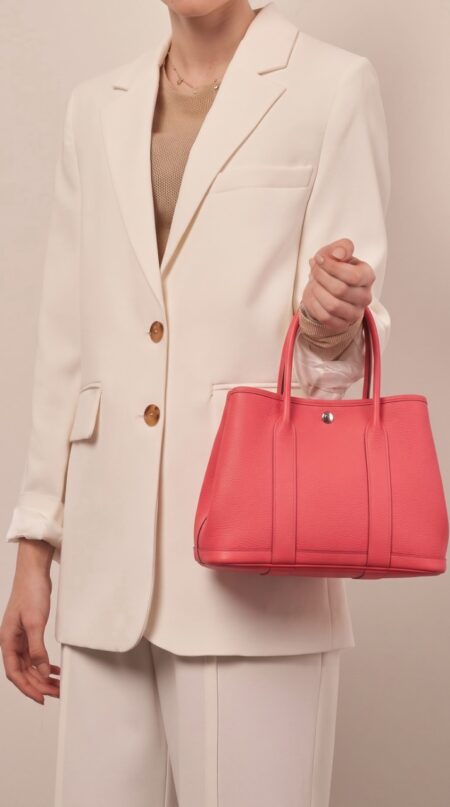 Model carrying the Bougainvillea Herme$ Garden Party 36 tote