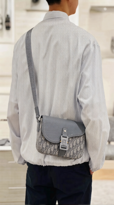 Model carrying the D!0r Small Saddle Messenger Bag with adjustable shoulder strap