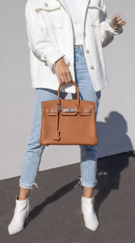 Model carrying the Brown Togo Herme$ Birkin 30 with palladium-tone hardware