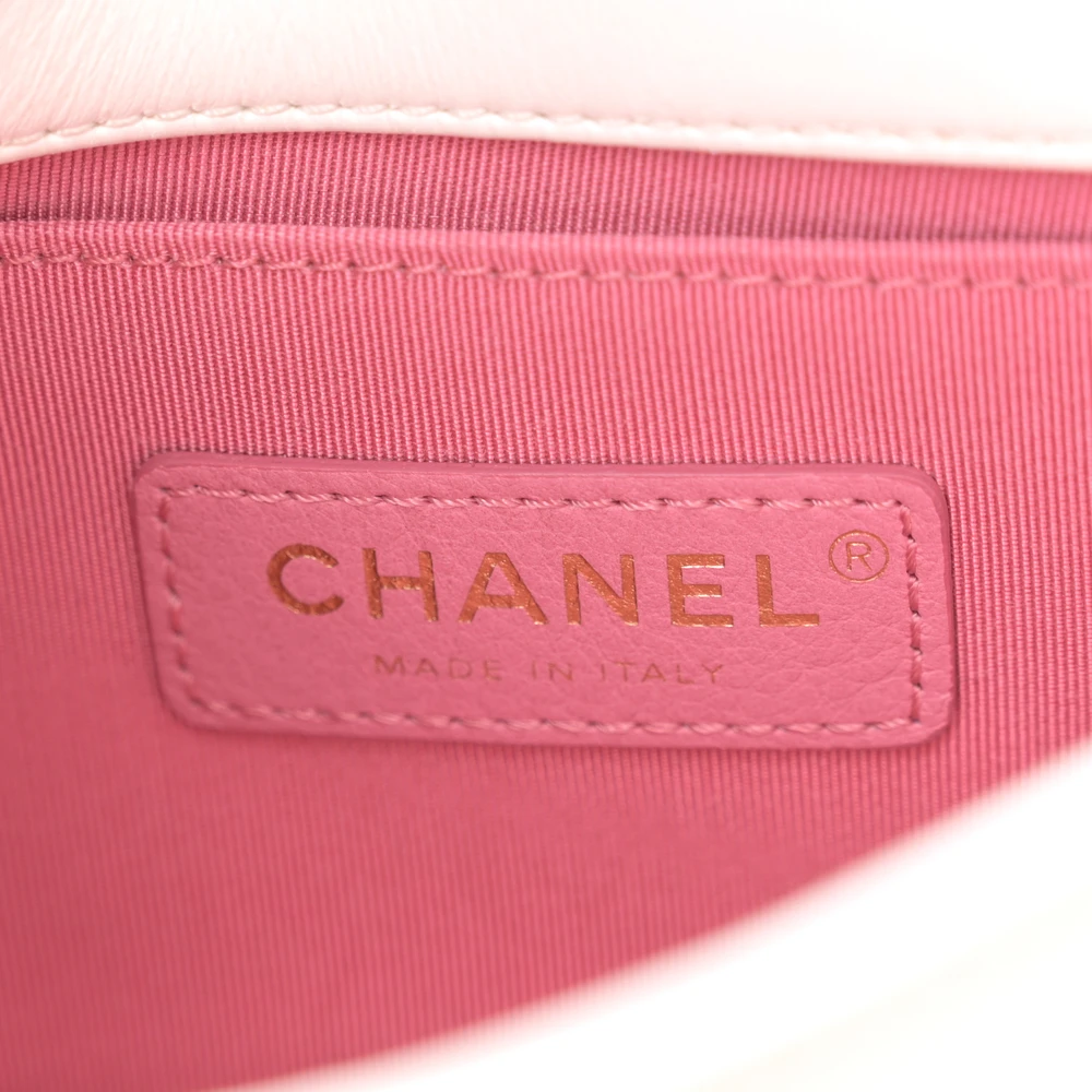 Close-up of the gold-tone CC turn-lock and multicoloured chain detailing on the white Ch@nel Chain Flap Bag