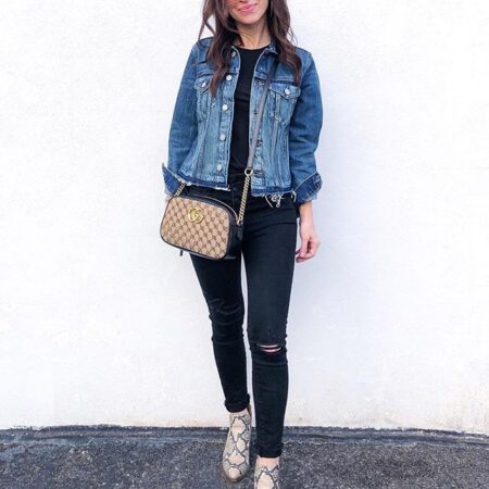 Model carrying the beige and black Gucc! Small GG Marmont chain shoulder bag
