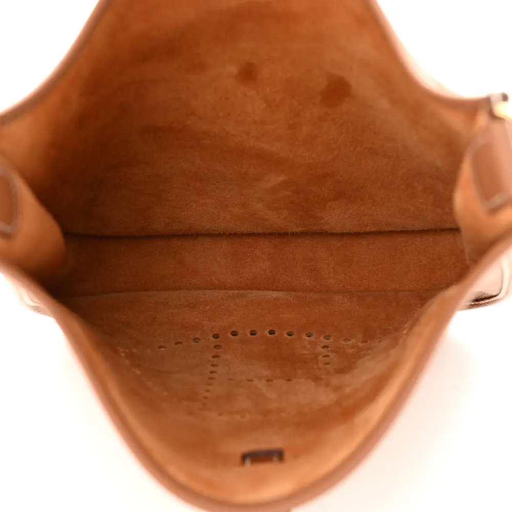 Interior view of the brown Taurillon Clemence Herme$ Evelyne III PM with spacious storage