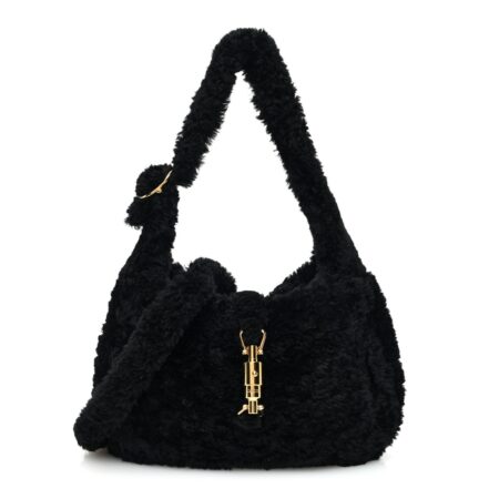 Front view of the black shearling Small Jackie 1961 Shoulder Bag with curved hobo silhouette