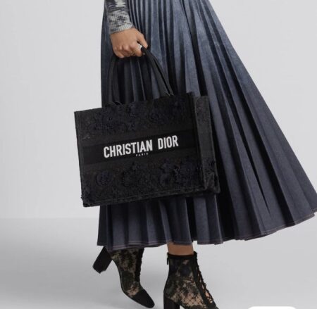 Model carrying the black and multicolour D!0r Medium Book Tote