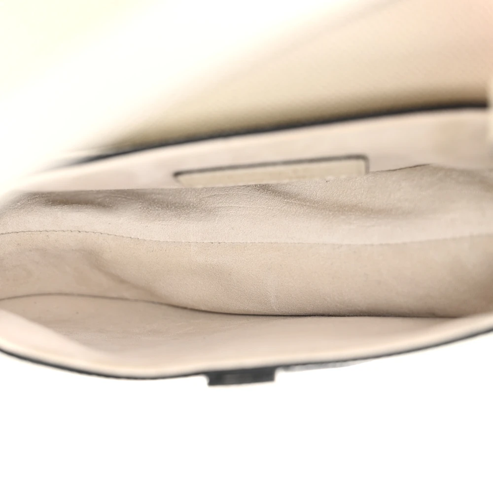 Interior view of the white D!0r Saddle Bag with its main compartment