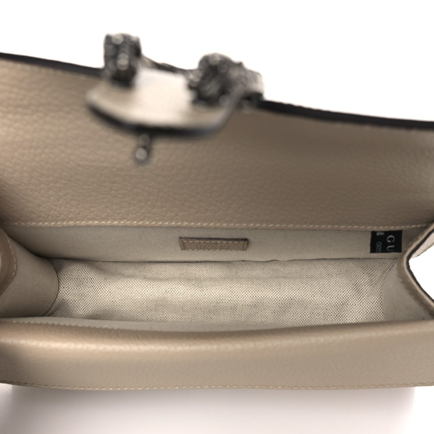 Interior view of the beige and white Gucc! Dionysus Shoulder Bag showing its main compartment and interior pockets