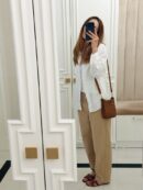 Model carrying the brown Taurillon Clemence Herme$ Evelyne TPM crossbody bag