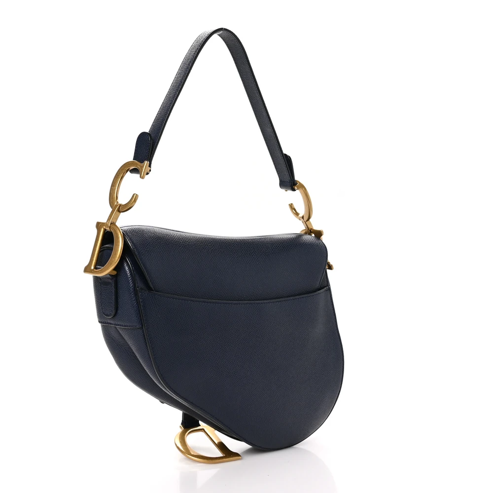 Back view of the navy blue grained calfskin D!0r Saddle Bag with its iconic curved silhouette