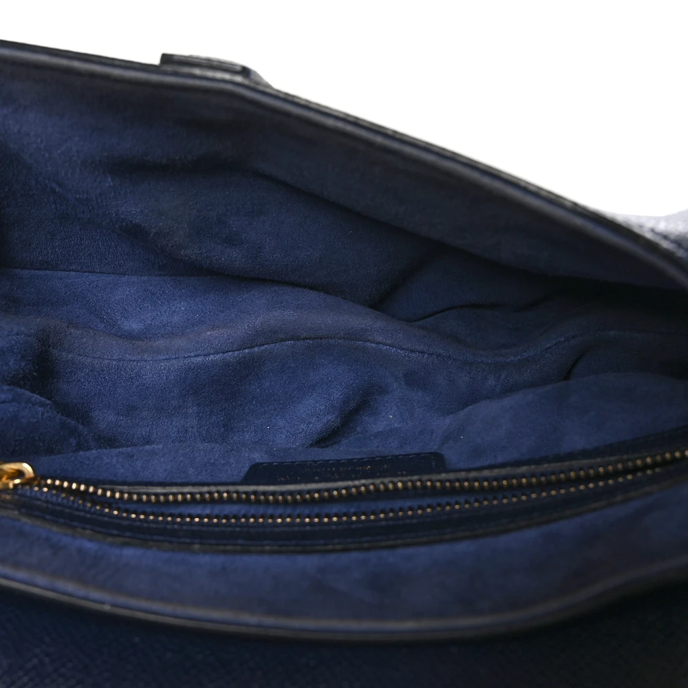 Interior view of the navy blue grained calfskin Saddle Bag with compact storage