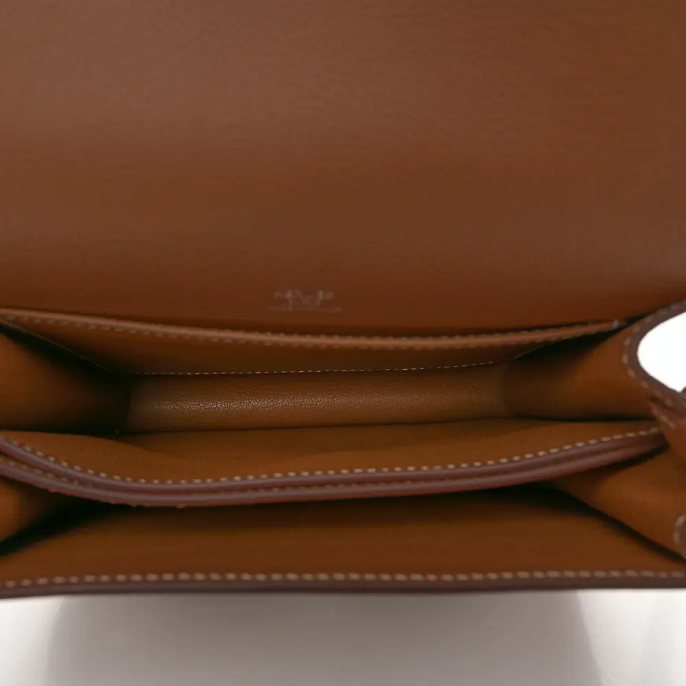 Interior view of the brown Evercolor Herme$ Mini Sac Roulis with its organised compartment