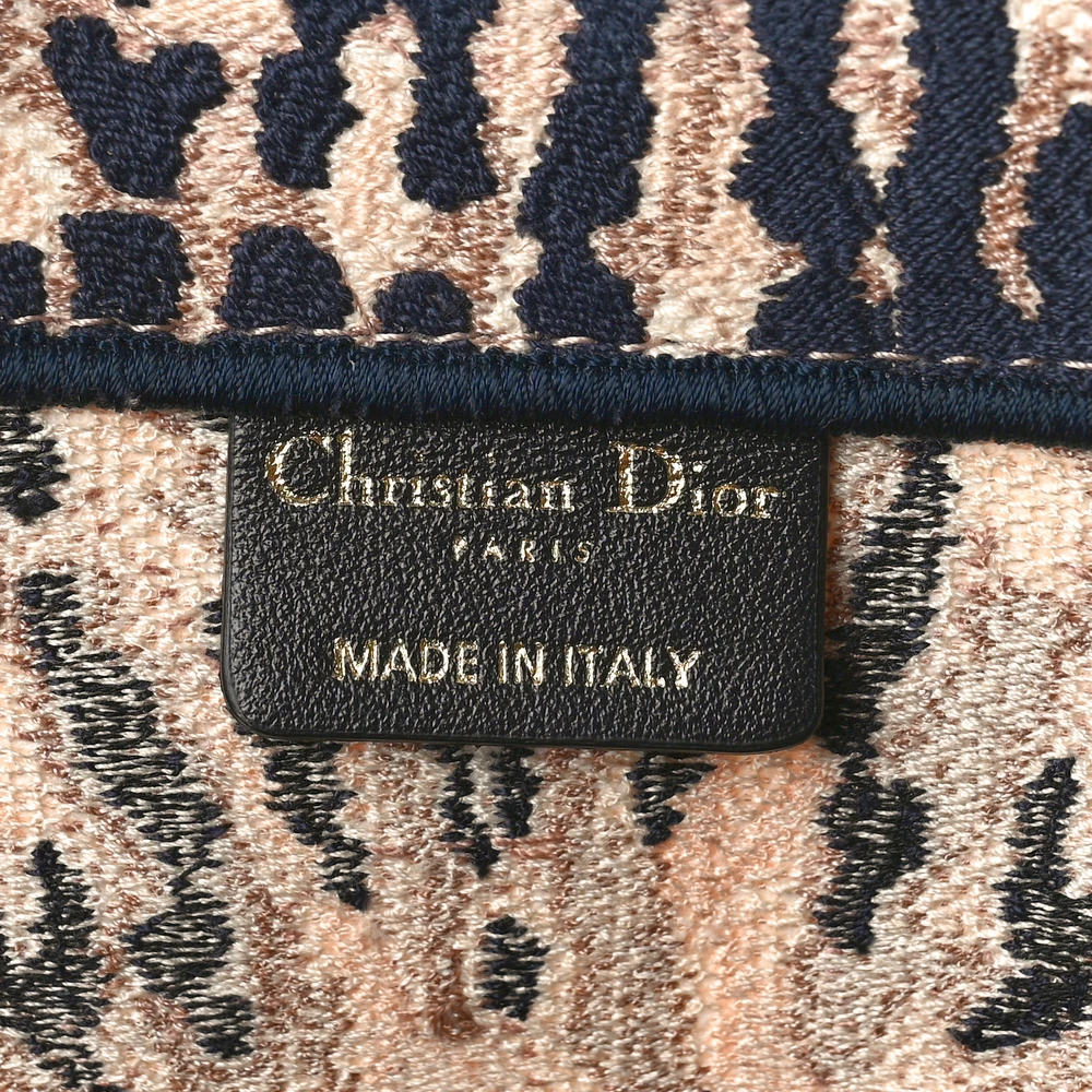 Close-up of the embroidered front lettering and multicolour tie-dye canvas detailing on the Large Book Tote