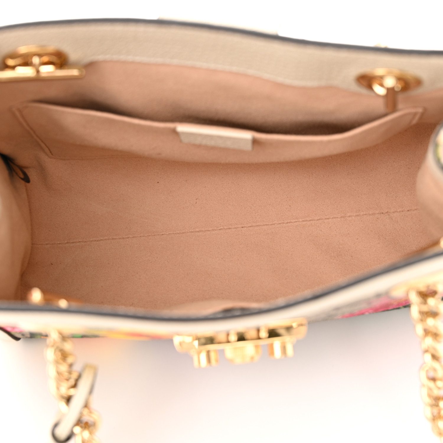 Interior view of the beige Gucc! Flora Padlock Tote showing its microfiber-style lining and organisational pockets