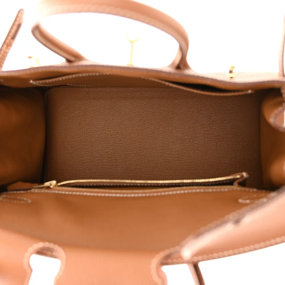 Interior view of the Brown Togo Herme$ Birkin 25 showing its leather-lined compartment and interior pocket
