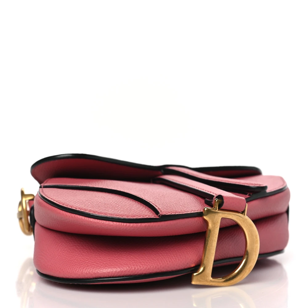 Bottom view of the pink grained calfskin D!0r Mini Saddle Bag with iconic curved Saddle silhouette