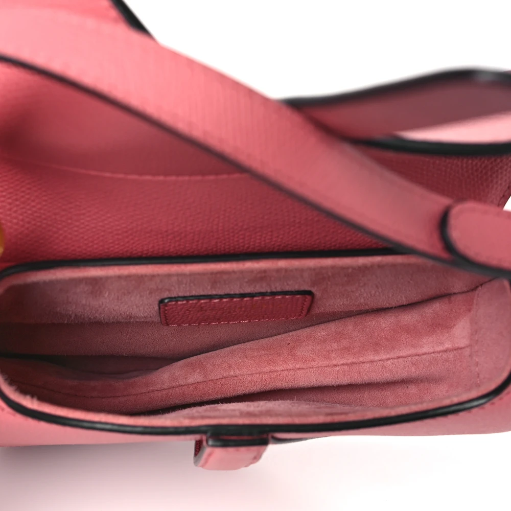 Interior view of the pink grained calfskin D!0r Mini Saddle Bag with compact storage