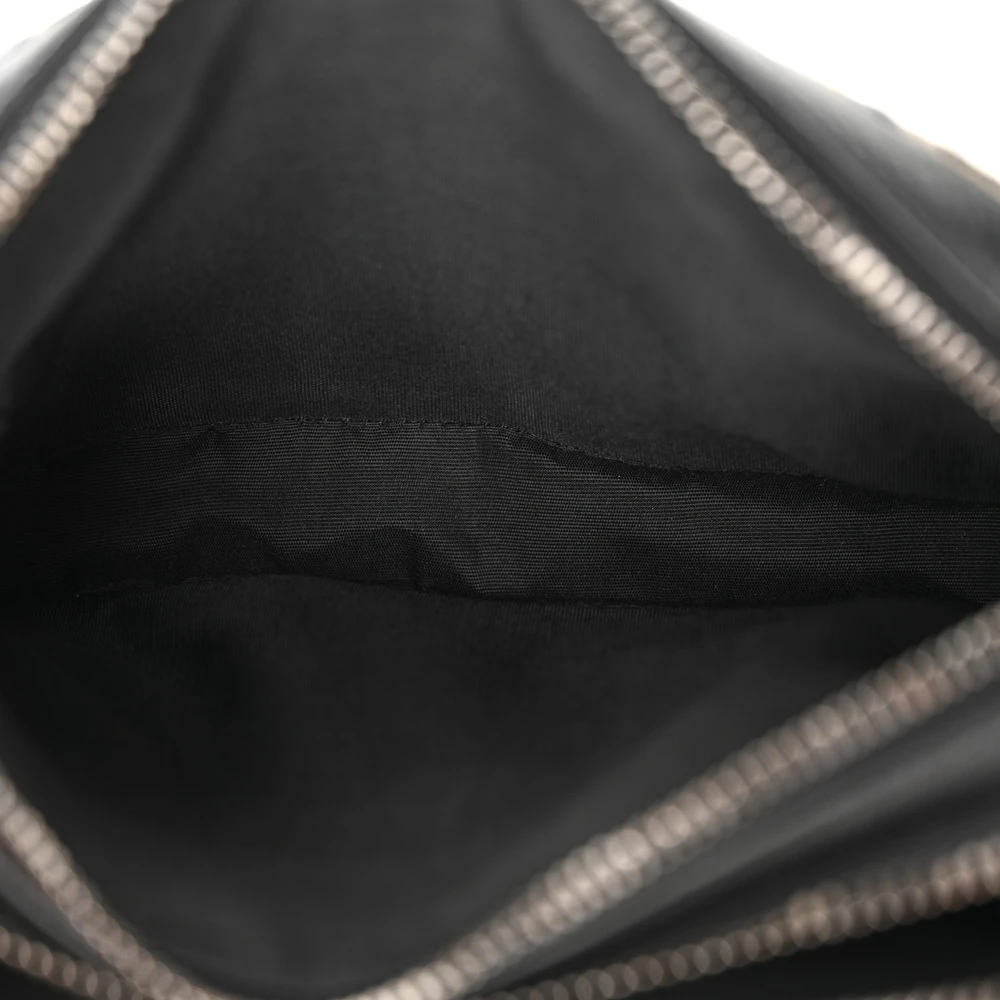 Interior view of the charcoal D!0r x Kenny Scharf Crossbody Bag with its main compartment