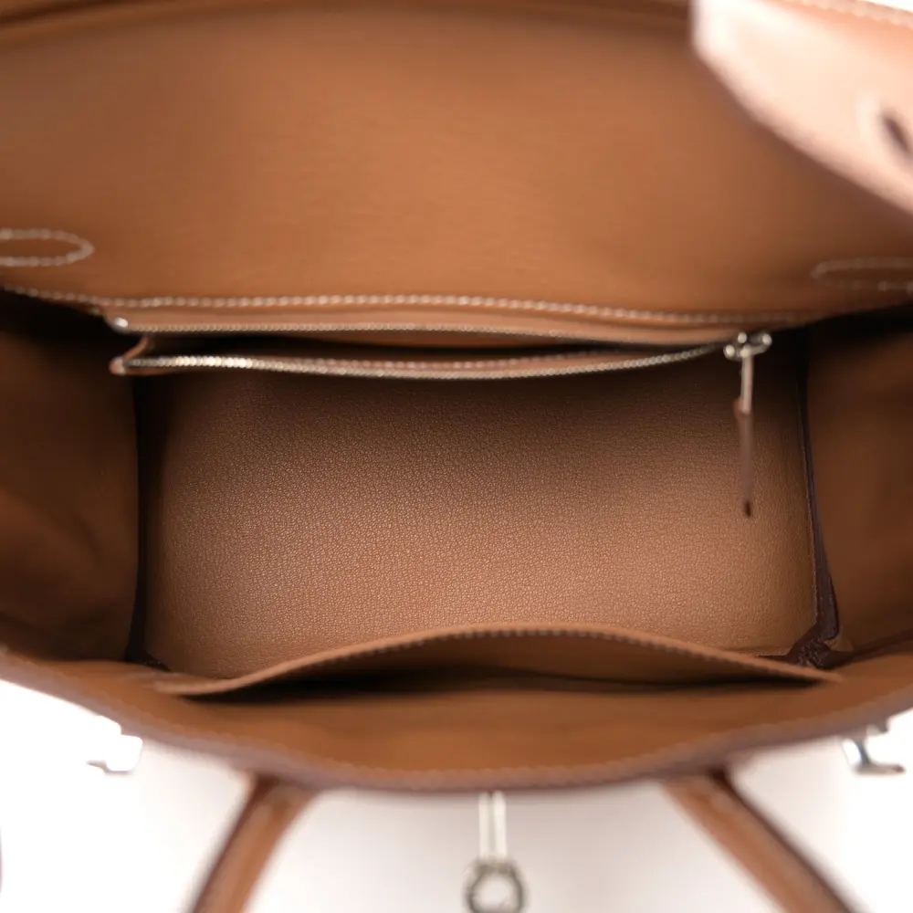Interior view of the Brown Togo Herme$ Birkin 25 showing its leather-lined compartment and interior pockets
