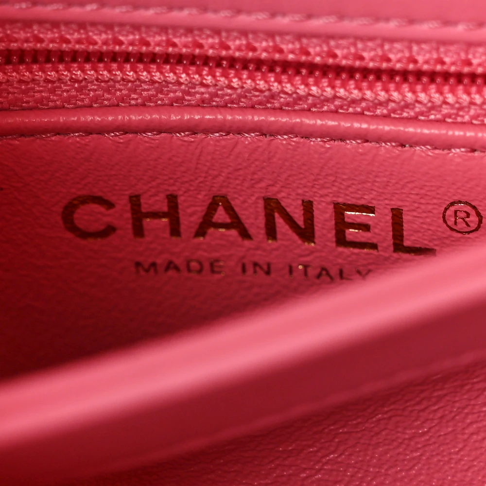 Close-up of the CC turn-lock and chain hardware on the vibrant pink Ch@nel Trendy CC Flap Bag