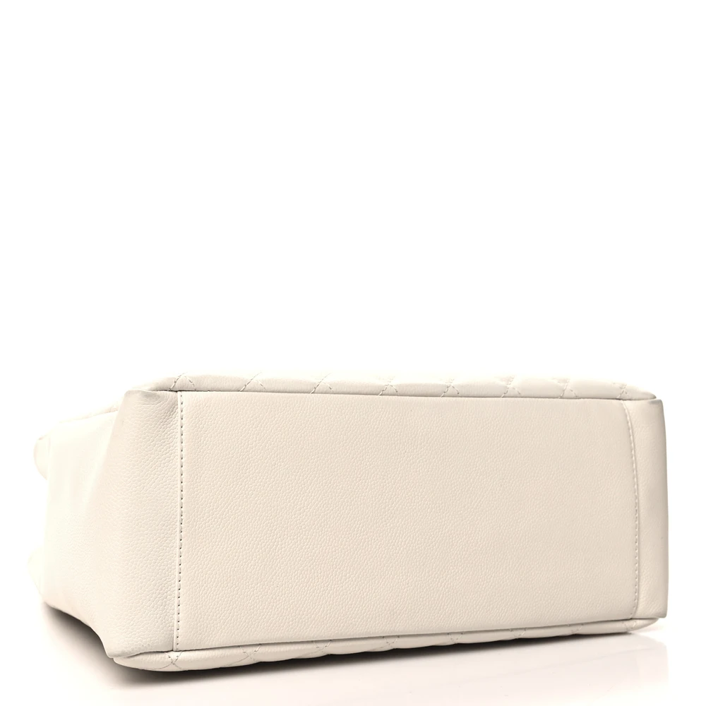 Bottom view of the white Ch@nel Grand Shopping Tote with stitched CC logo and silver-tone chain straps