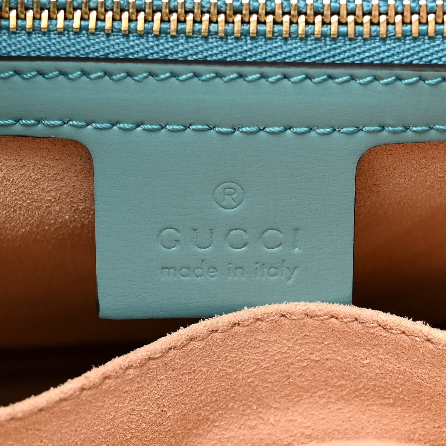 Close-up of the piston-style closure, leather strap, and refined hardware on the dusty azure Jackie 1961 Hobo