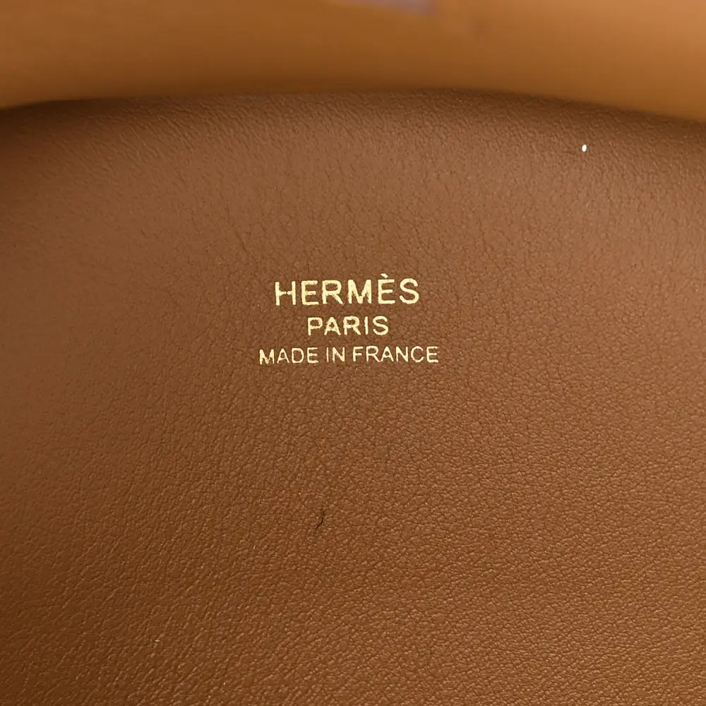 Close-up of the gold-tone turn-lock, front flap, and hardware on the Bronze Dore shoulder bag