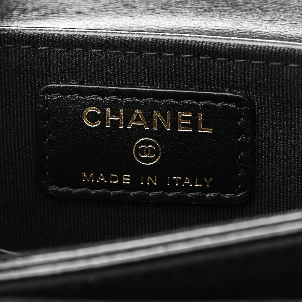 Close-up of the CC logo detailing and gold-tone hardware on the black Ch@nel Flap Phone Holder