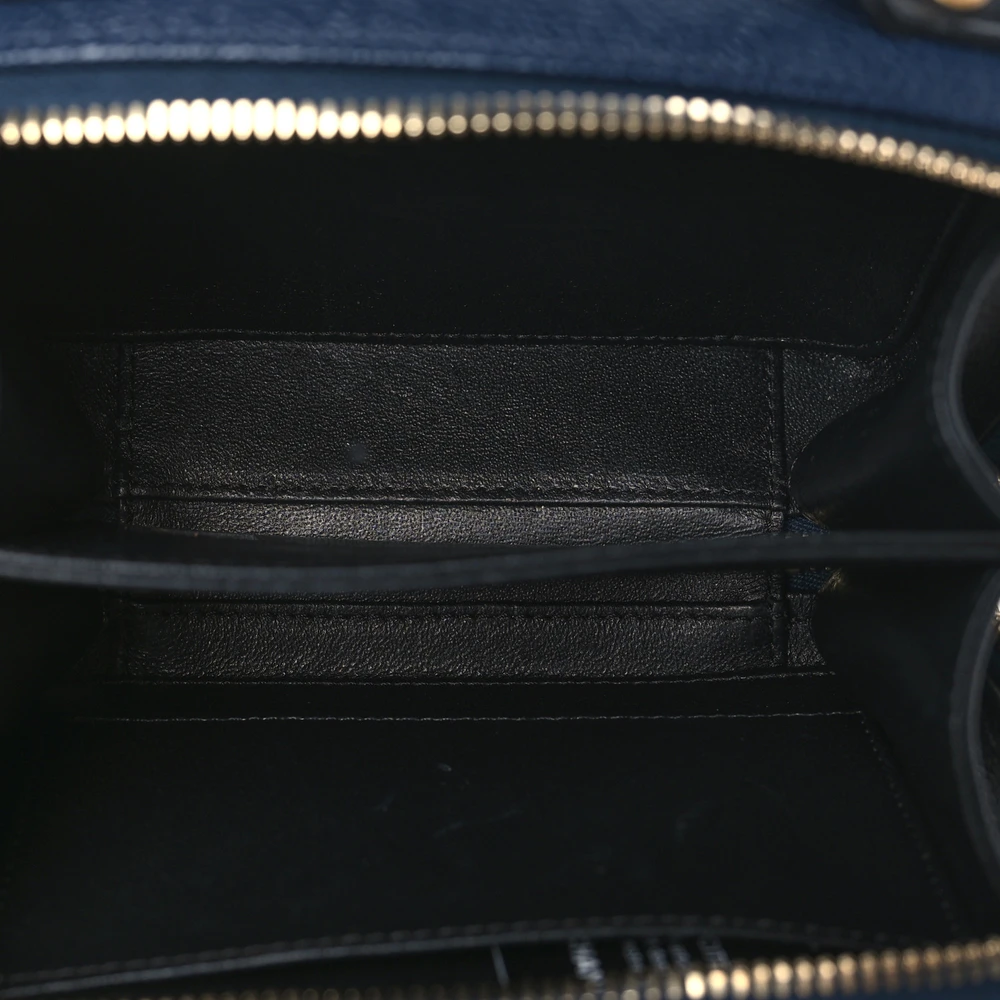 Interior view of the navy Ch@nel Filigree Vanity Case showing its burgundy leather-style lining and patch pocket