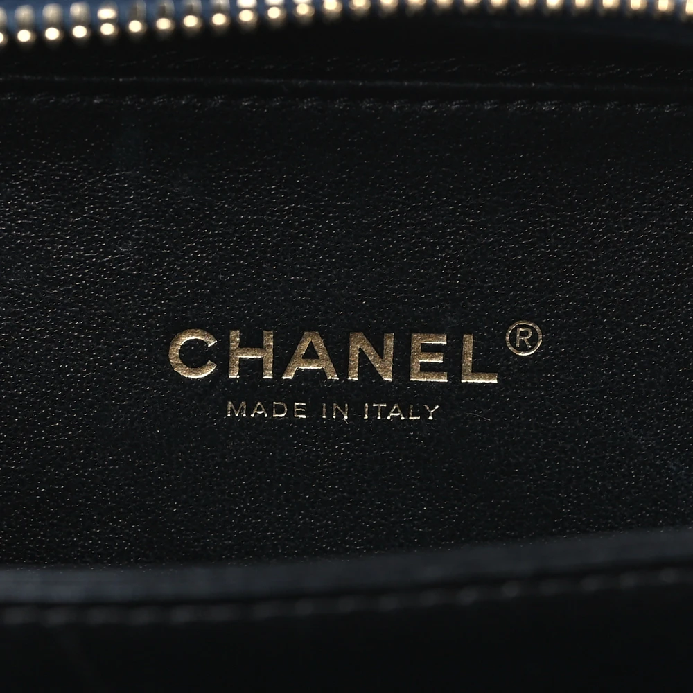 Close-up of the gold-tone hardware and chain strap on the navy Ch@nel Filigree Vanity Case