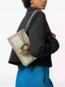 Model carrying the beige and white GG Dionysus Shoulder Bag with chain shoulder strap