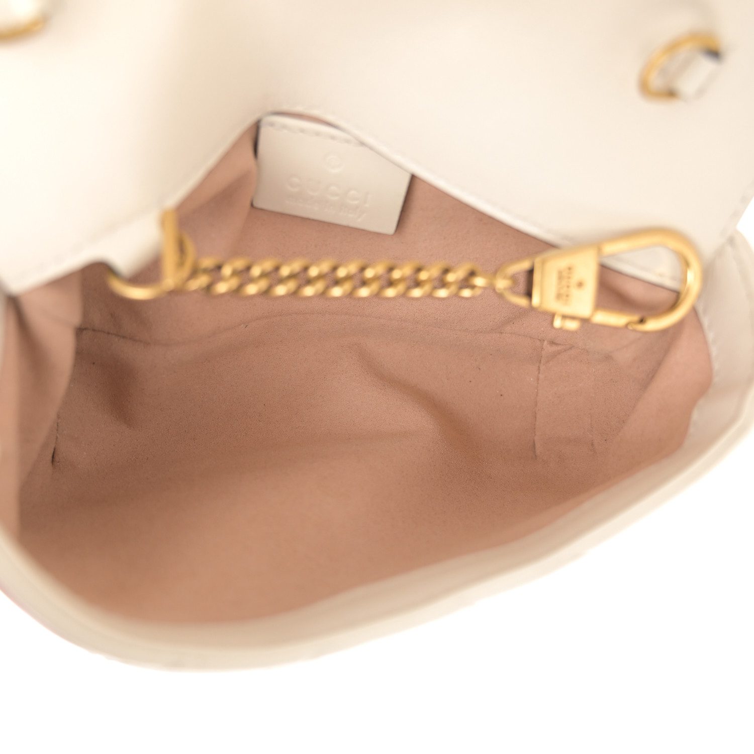 Interior view of the white Gucc! Super Mini GG Marmont showing the light beige fabric lining and removable key ring