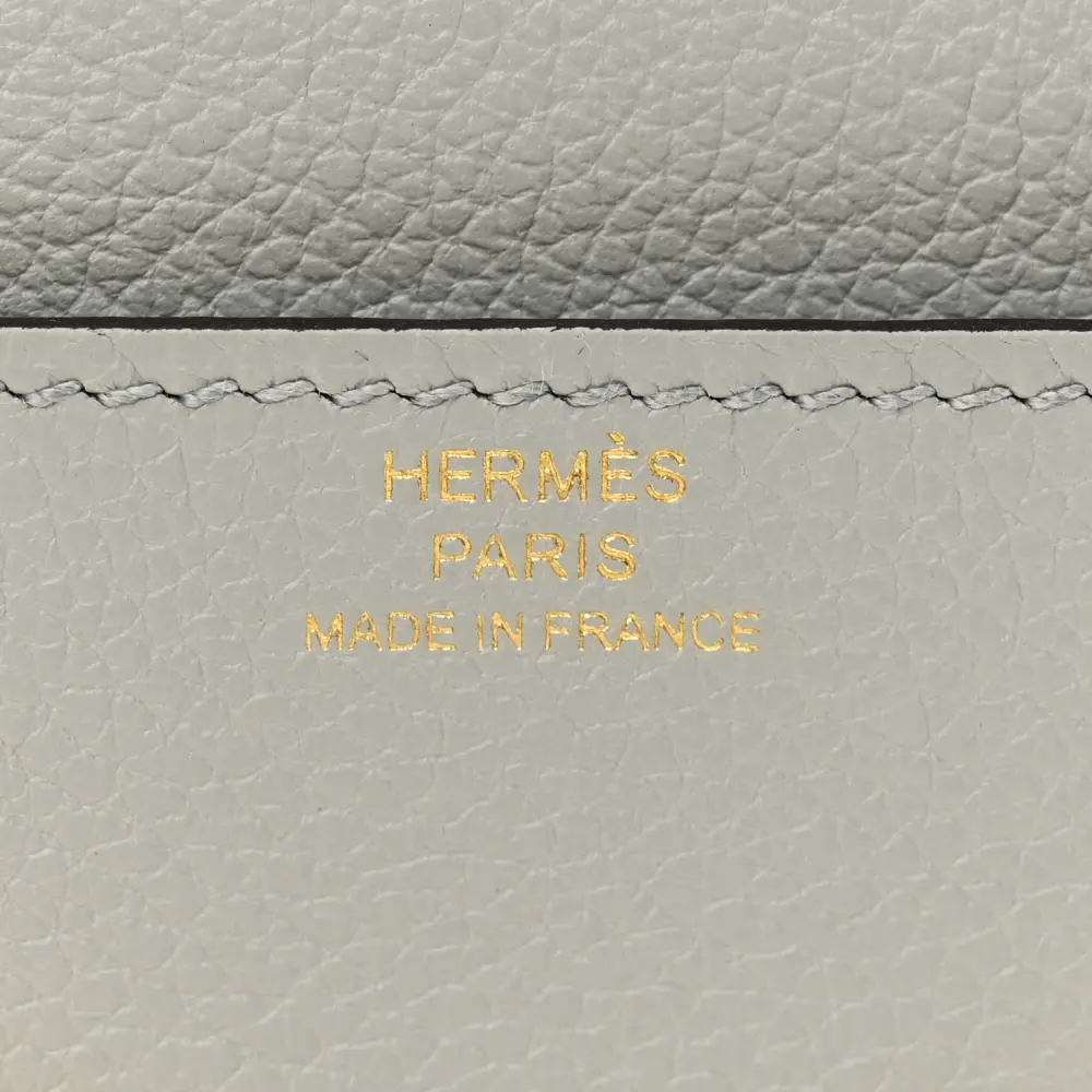 Close-up of the H closure, leather texture, and refined hardware on the Bleu Glacier Constance Wallet To Go