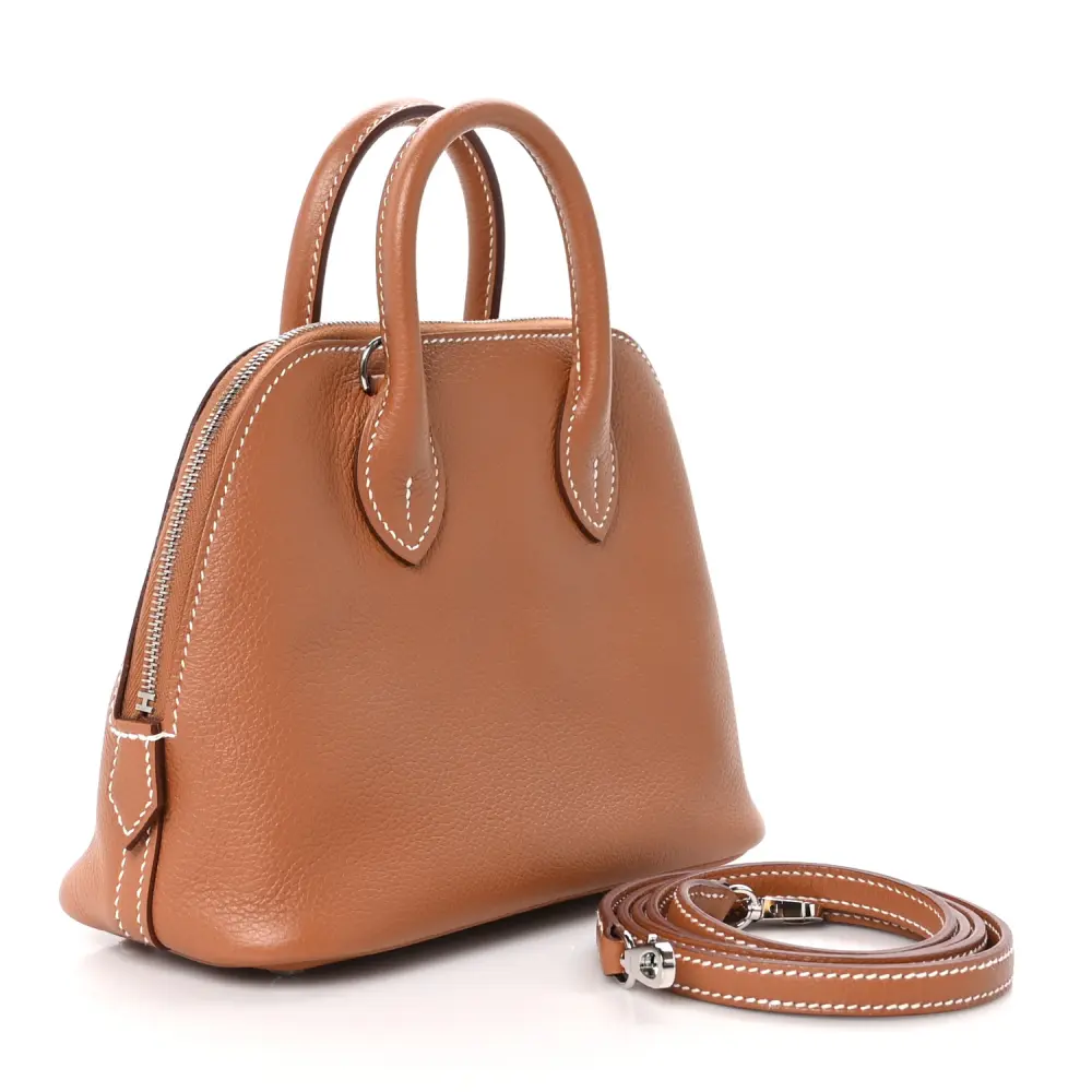 Back view of the brown Hermès Mini 1923 Bolide showing its structured base and metal feet