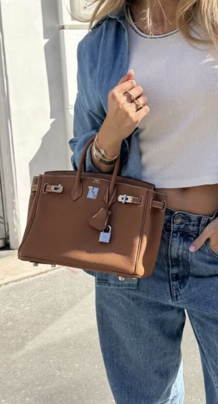 Model carrying the brown Togo Herme$ Birkin 25 with silver tone hardware