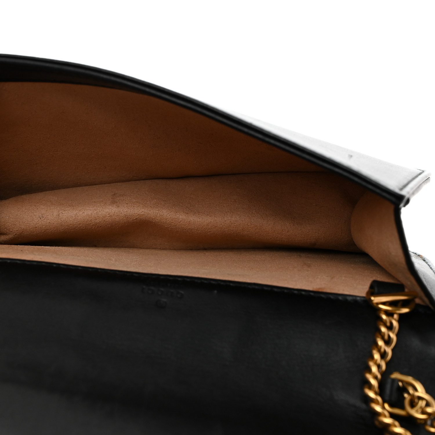 Interior of the black Gucci GG Marmont Mini Bag with beige microfiber lining and key ring clasp
