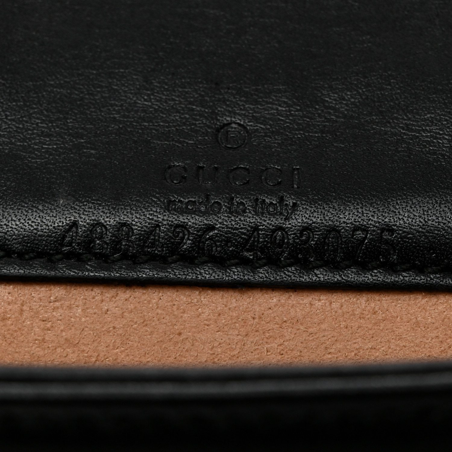 Close-up of the aged gold-tone interlocking GG logo on the black Gucc! GG Marmont Mini Bag