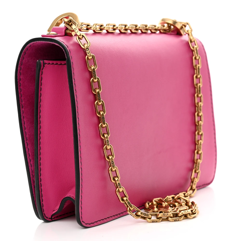 Back view of the fuchsia D!0r J’Adior Chain Flap Bag with signature logo on the flap