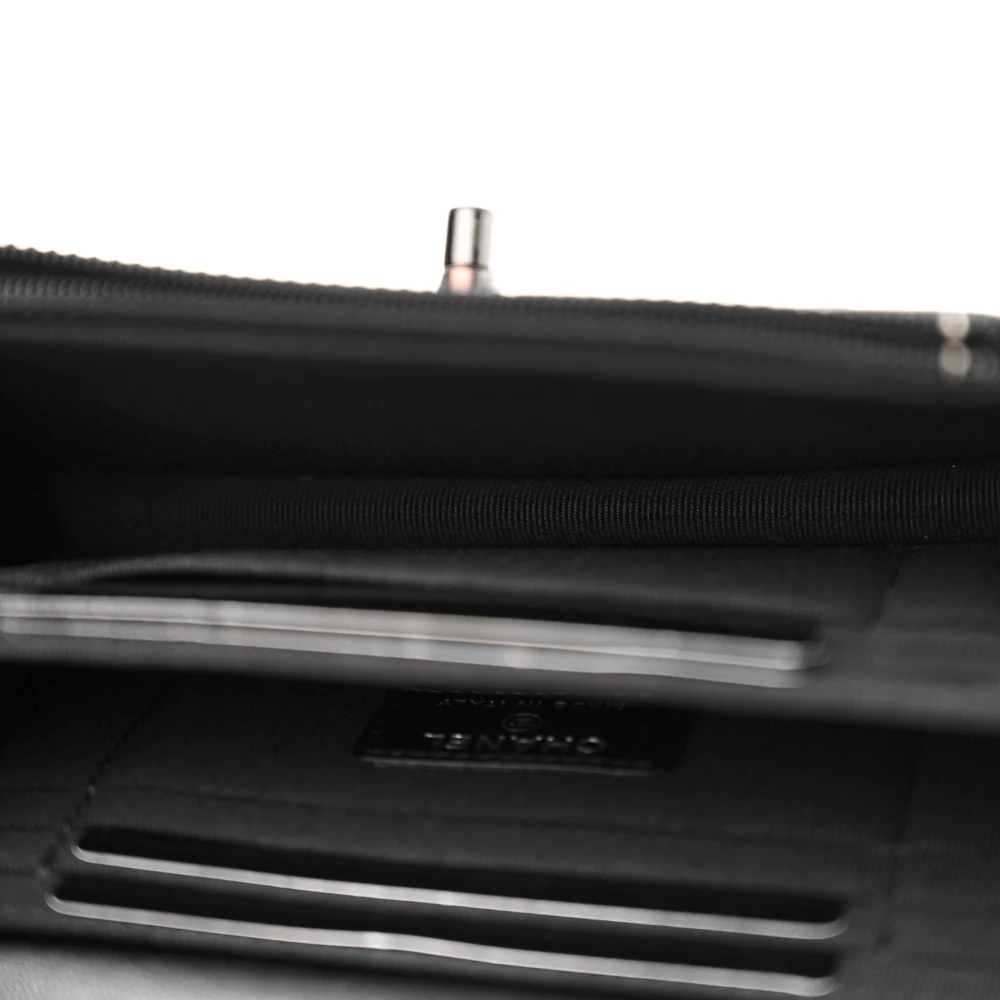 Organised interior of the black Ch@nel Mini WOC with card slots, patch pockets and zipper compartment