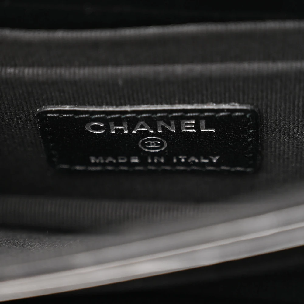 Close-up of the Black-tone CC turn-lock clasp on the black Mini WOC