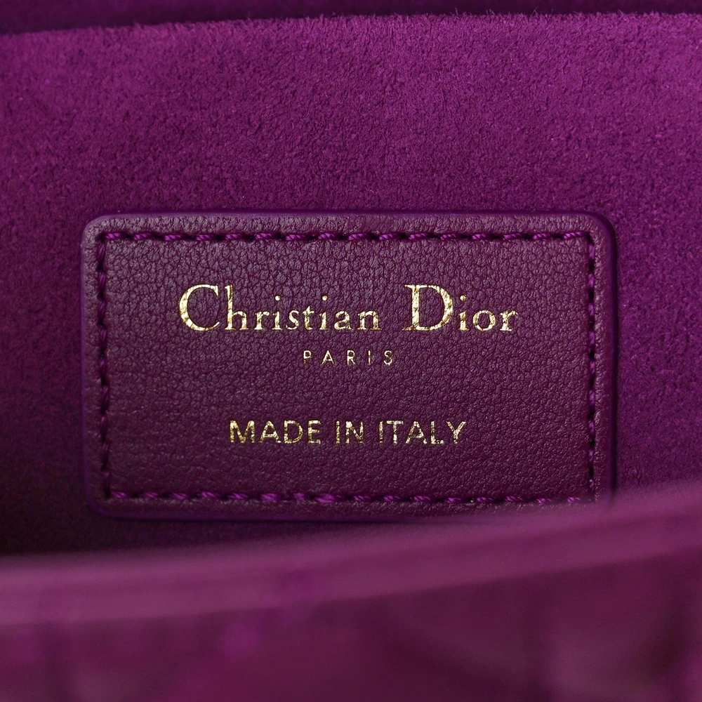 Close-up of gold-tone D.I.O.R. charms and hardware on the purple Lady D-Joy bag