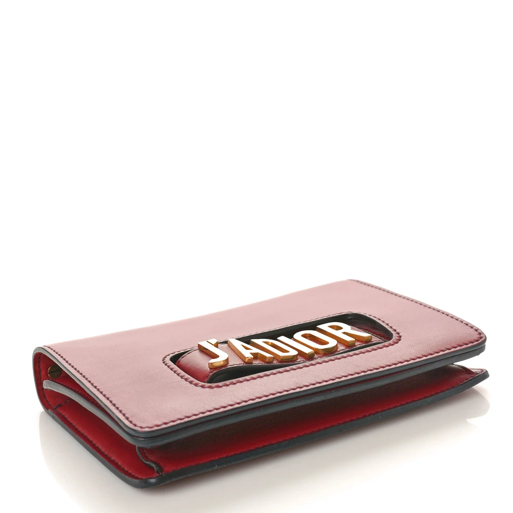 Bottom view of the red D!0r J’Adior Chain Flap Bag with gold-tone J’ADIOR signature