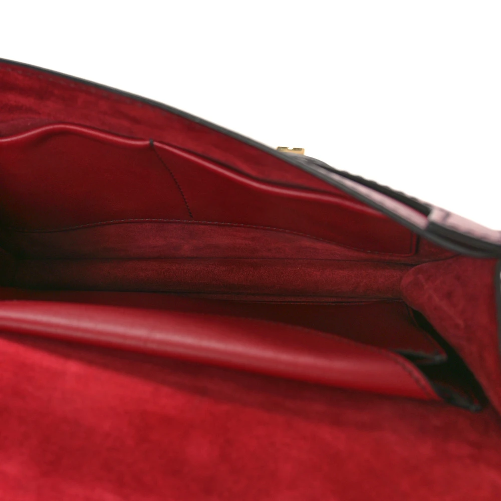 Interior view of the red D!0r J’Adior Chain Flap Bag with fabric lining and single compartment
