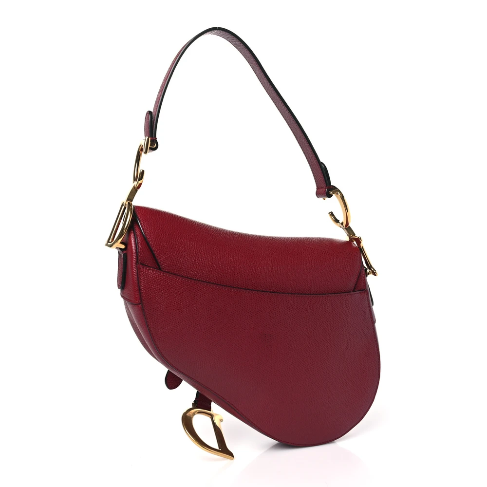Back view of the red D!0r Saddle Bag with iconic curved silhouette and magnetic D stirrup clasp